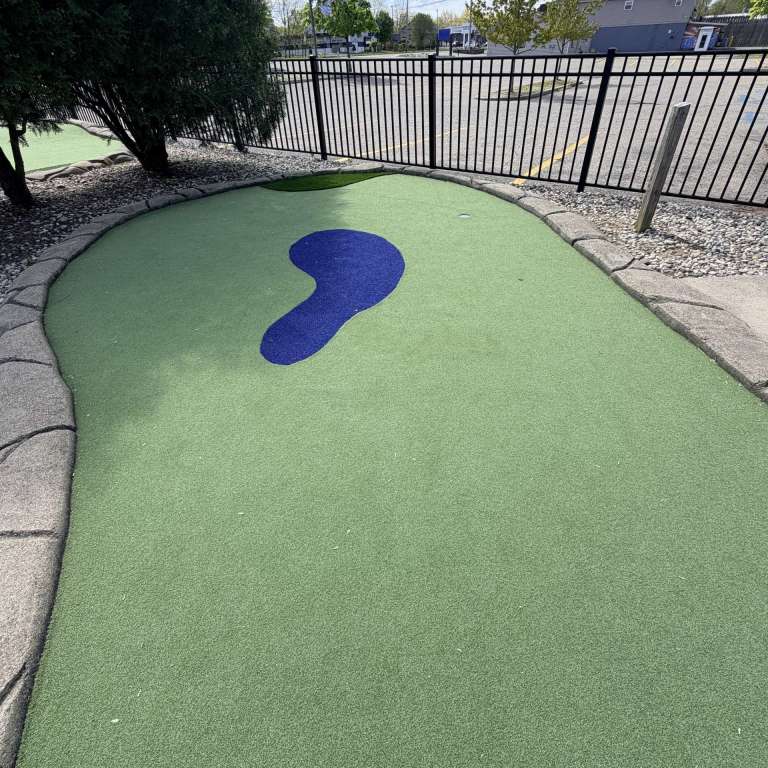 A blue turf water hazard on our mini golf course