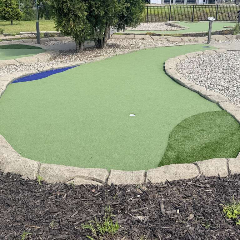 Fresh synthetic putting turf on a mini golf hole