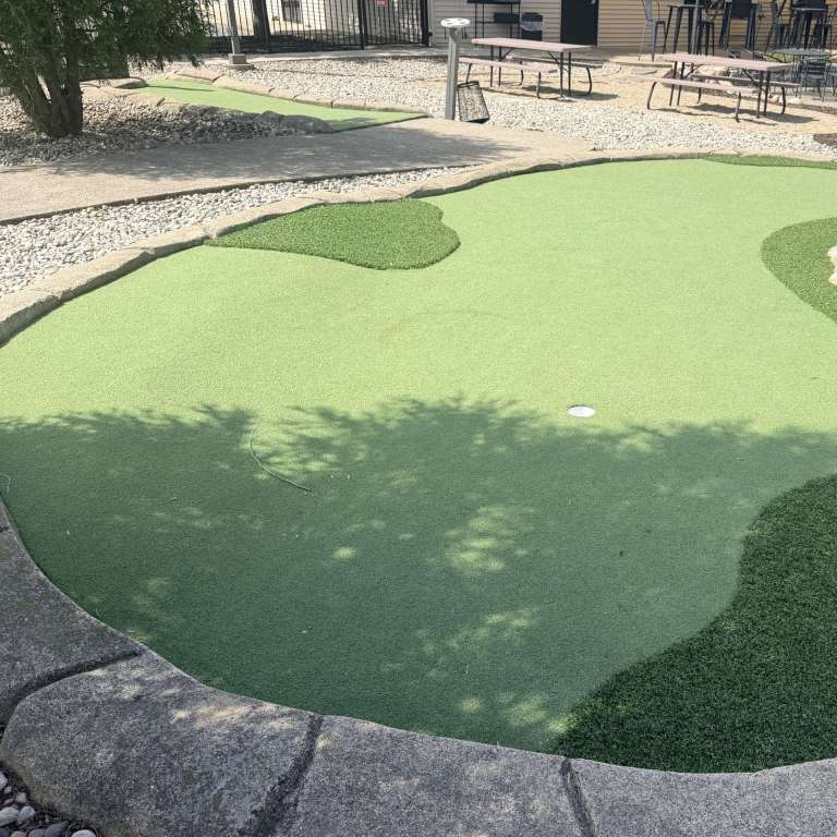 A hole on our mini golf green